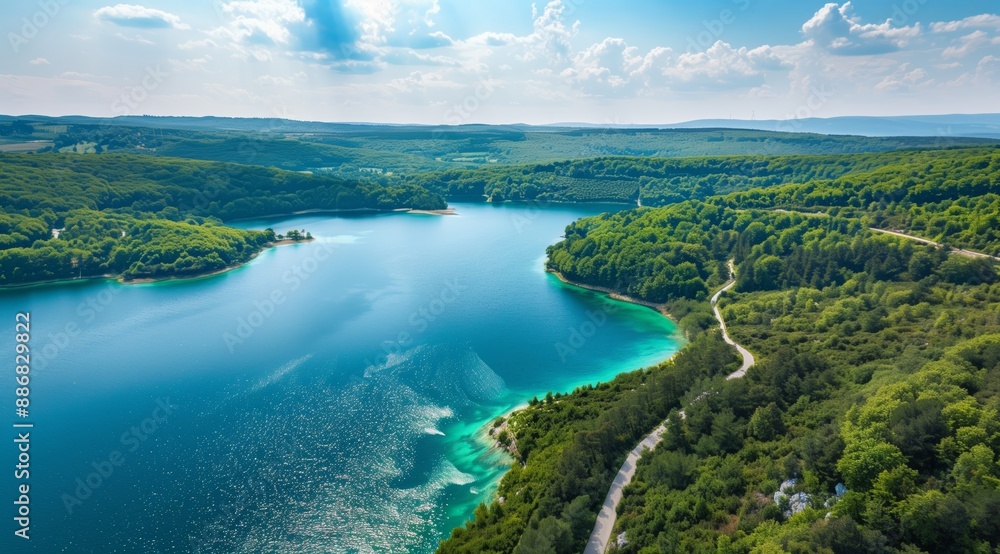 Aerial View of Lake and Forest Landscape with Winding Road Aerial View of Lake and Forest Landscape with Winding Road