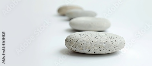 Zen stone scales resting on a white background, demonstrating balance and tranquility, ideal for a copy space image.