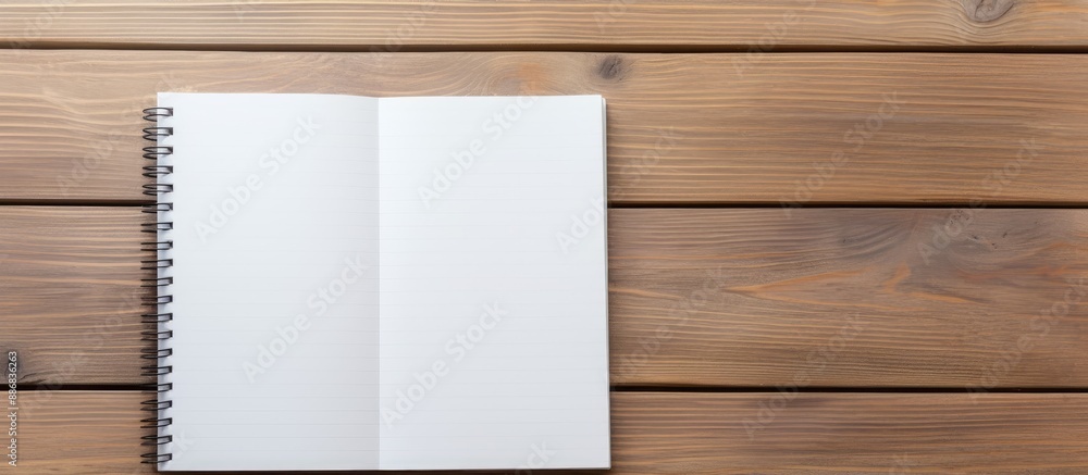 Notebook and pen on a wooden table with available space for text or education message in the image. Notebook and pen on a wooden table with available space for text or education message in the image.
