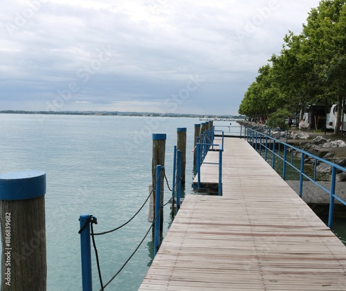 Garda lake  is the largest lake in Italy. It is a popular holiday location in northern Italy, between Brescia and Milan to the west, and Verona and Venice to the east. photo