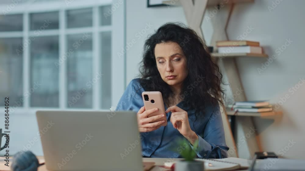 Bored worker checking phone in office. Thoughtful businesswoman taking break Bored worker checking phone in office. Thoughtful businesswoman taking break