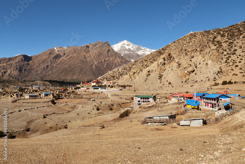 View onto the traditional mountain village of Ngawal, the snow capped peak of Chulu East is rising in the background, Annapurna Circuit Trek, Nepal photo