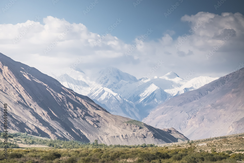 Panorama of Tien Shan mountain range with snow and glaciers, and rocky peaks in Tajikistan in Pamir, mountain range for background in evening Panorama of Tien Shan mountain range with snow and glaciers, and rocky peaks in Tajikistan in Pamir, mountain range for background in evening