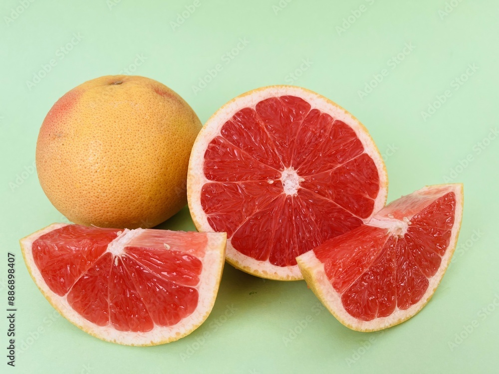 Fresh grapefruit fruit. Grapefruit isolated on green background. Grapefruit with clipping path. Fresh grapefruit fruit. Grapefruit isolated on green background. Grapefruit with clipping path.