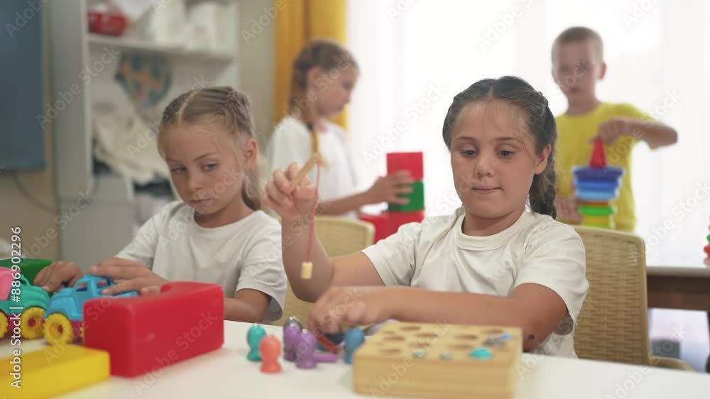 child group playing fishing. children in kindergarten play with toys. happy family kid dream concept. a group of children collect building lifestyle blocks in a kindergarten indoors child group playing fishing. children in kindergarten play with toys. happy family kid dream concept. a group of children collect building lifestyle blocks in a kindergarten indoors