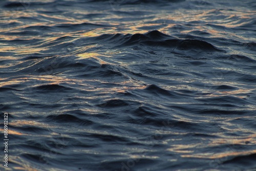 Photography Shallow depth of field shot of waves in the sea at sunset.