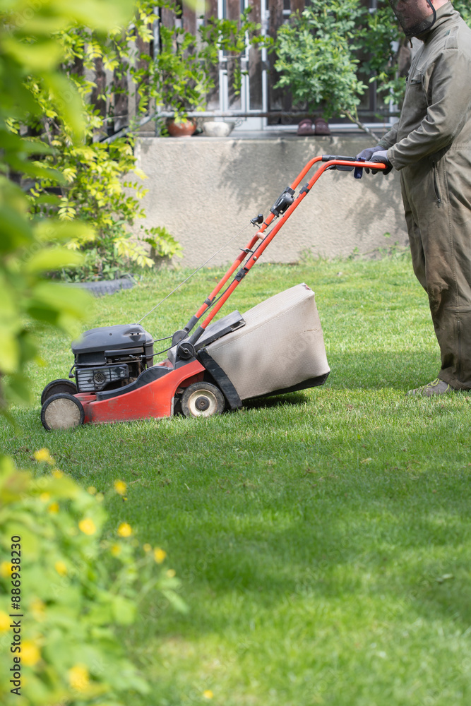 Fototapeta premium Lawn mover on green grass. Machine for cutting lawns.