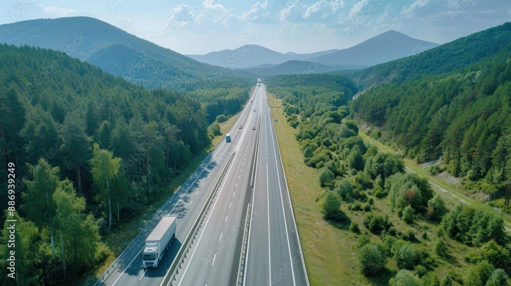 Obraz premium Aerial View of Highway Surrounded by Lush Green Mountains