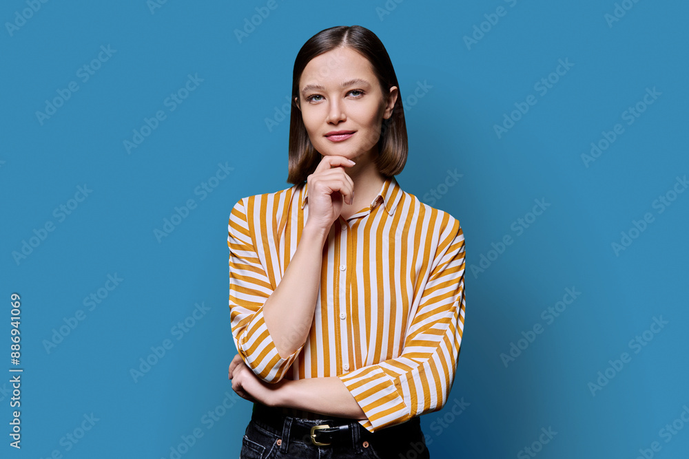 Young beautiful smiling woman on blue background Young beautiful smiling woman on blue background