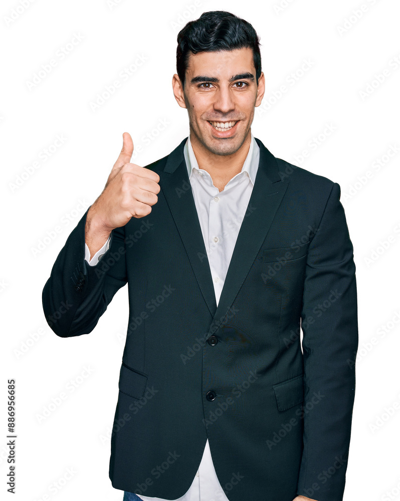 Handsome hispanic man wearing business clothes doing happy thumbs up gesture with hand. approving expression looking at the camera showing success. Handsome hispanic man wearing business clothes doing happy thumbs up gesture with hand. approving expression looking at the camera showing success.
