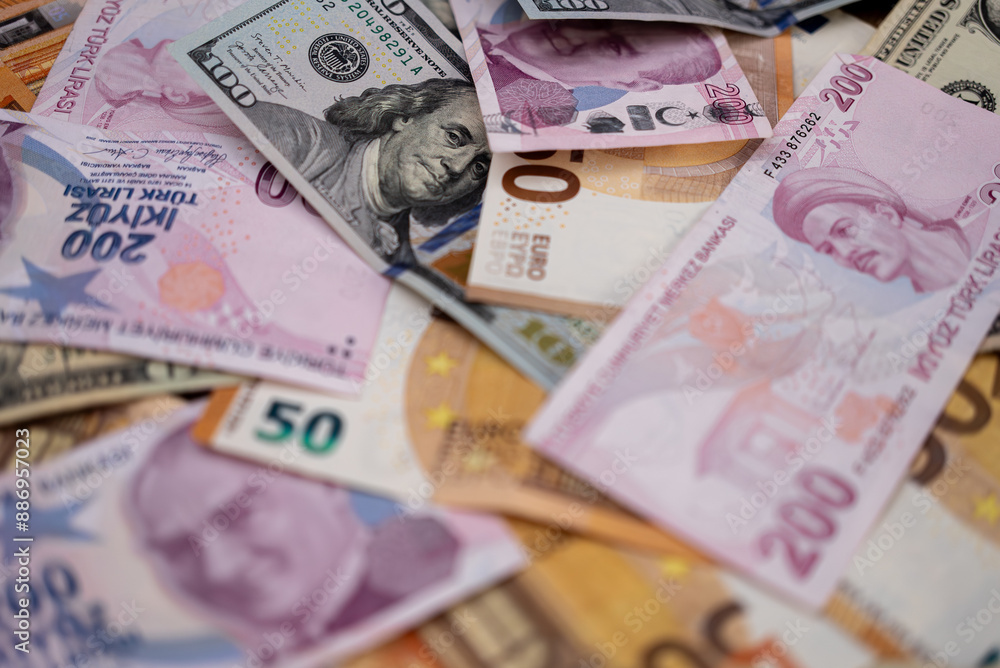Fototapeta premium Turkish lira and dollar banknotes put on table demonstrate concept of exchange rate of volatile currency with high inflation to primary reserve currency