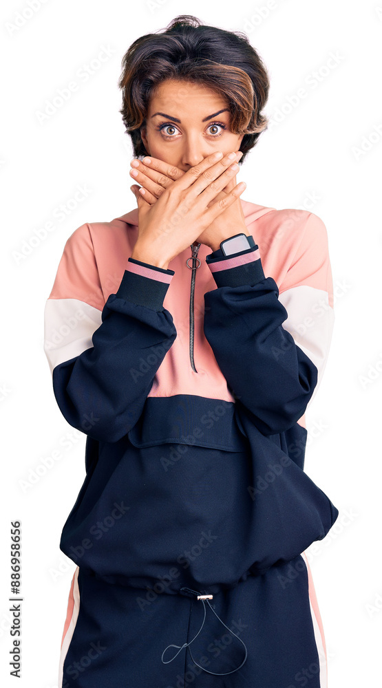 Young beautiful woman wearing sportswear shocked covering mouth with hands for mistake. secret concept. Young beautiful woman wearing sportswear shocked covering mouth with hands for mistake. secret concept.