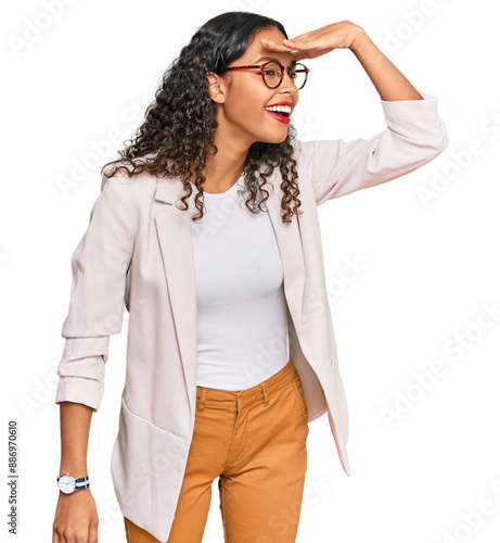 Fotografie Young african american girl wearing business clothes very happy and smiling looking far away with hand over head