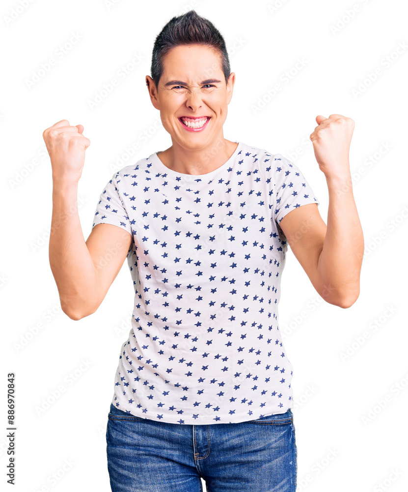 Young woman with short hair wearing casual clothes screaming proud, celebrating victory and success very excited with raised arms Young woman with short hair wearing casual clothes screaming proud, celebrating victory and success very excited with raised arms