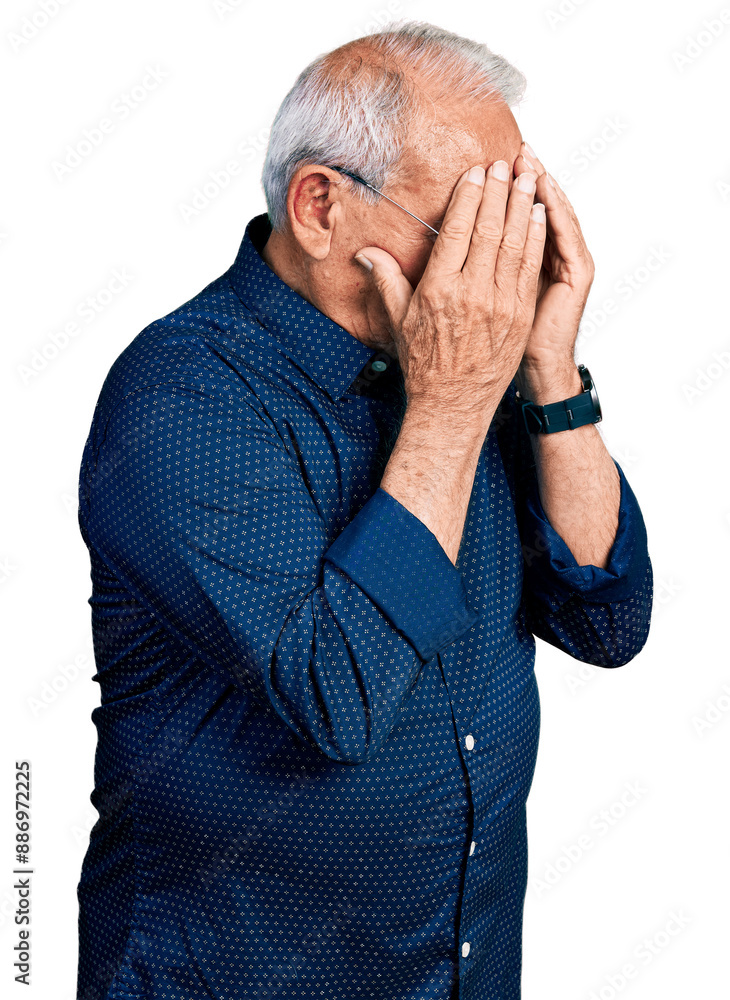 Senior man with grey hair wearing casual shirt and glasses with sad expression covering face with hands while crying. depression concept. Senior man with grey hair wearing casual shirt and glasses with sad expression covering face with hands while crying. depression concept.