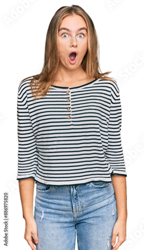 Beautiful blonde woman wearing casual clothes afraid and shocked with surprise expression, fear and excited face.