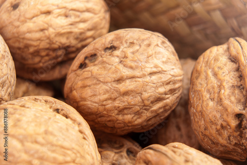 Whole organic walnuts with detailed textured shell close up view. Sustainable food ingredients. Macro shot.  © Pavel Iarunichev