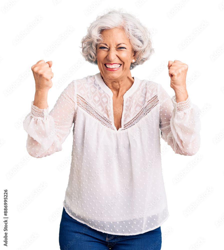Senior grey-haired woman wearing casual clothes very happy and excited doing winner gesture with arms raised, smiling and screaming for success. celebration concept. Senior grey-haired woman wearing casual clothes very happy and excited doing winner gesture with arms raised, smiling and screaming for success. celebration concept.