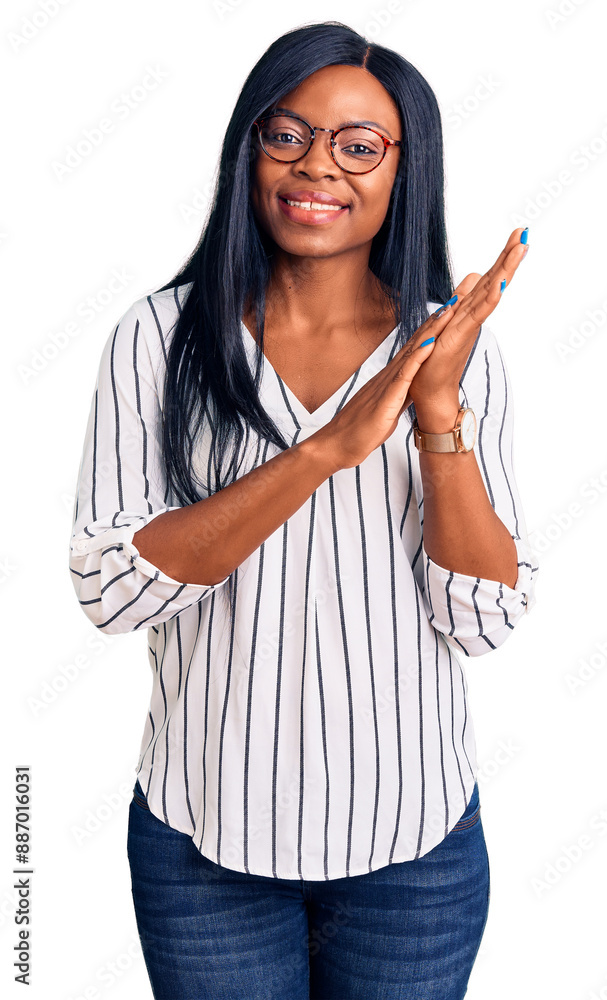Young african american woman wearing casual clothes and glasses clapping and applauding happy and joyful, smiling proud hands together Young african american woman wearing casual clothes and glasses clapping and applauding happy and joyful, smiling proud hands together