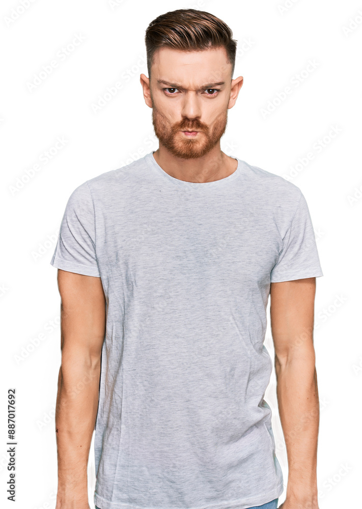 Young redhead man wearing casual grey t shirt depressed and worry for distress, crying angry and afraid. sad expression. Young redhead man wearing casual grey t shirt depressed and worry for distress, crying angry and afraid. sad expression.