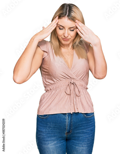 Young caucasian woman wearing casual clothes with hand on head for pain in head because stress. suffering migraine.