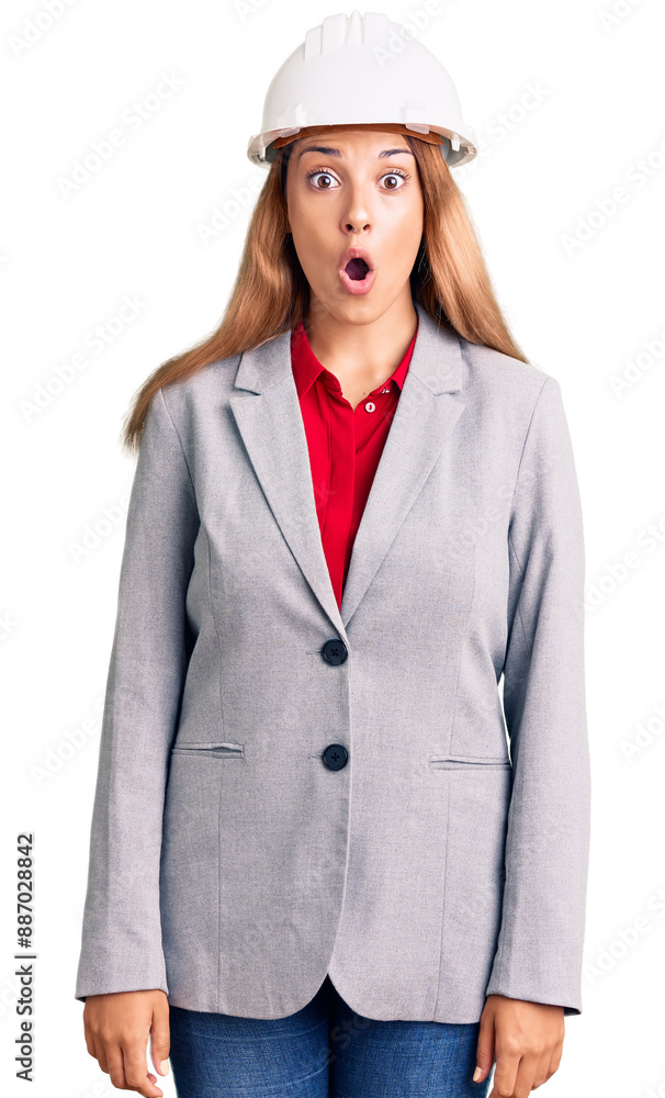 Beautiful young woman wearing architect hardhat afraid and shocked with surprise expression, fear and excited face. Beautiful young woman wearing architect hardhat afraid and shocked with surprise expression, fear and excited face.