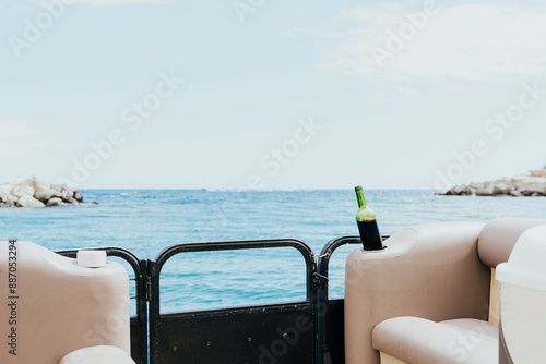 Relaxing boat scene with a bottle of wine on the sea photo