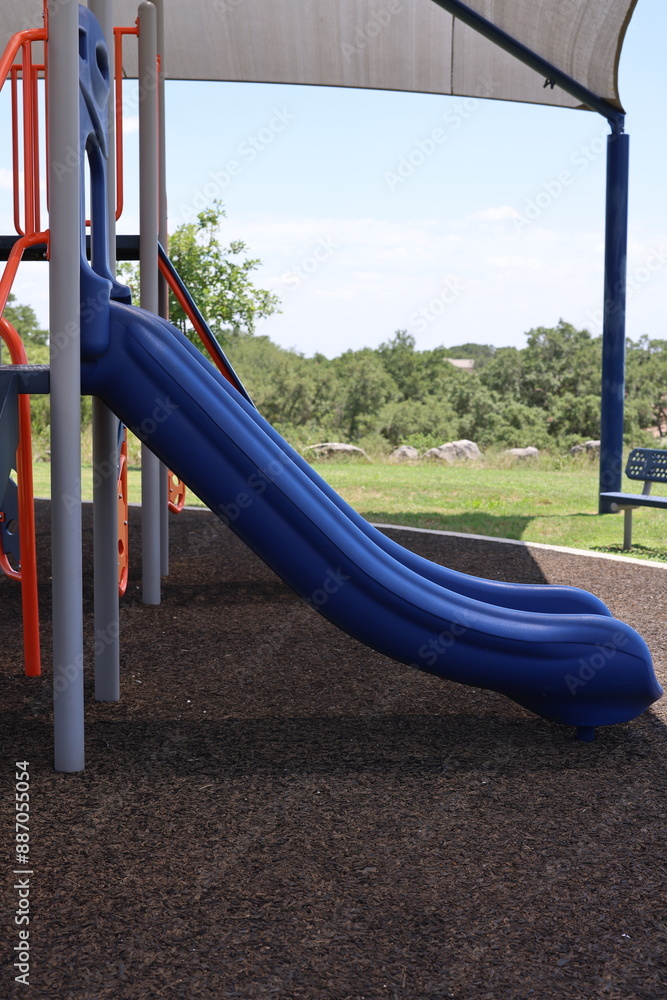 Blue slide in outdoor playground for children. Blue slide in outdoor playground for children.