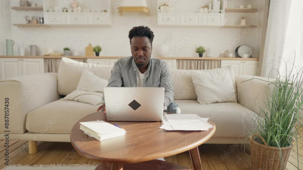 Handsome black man working remotely from home office, male person with laptop. Freelance and online job, African American businessman typing, sending messages in working chat, part time job in web Handsome black man working remotely from home office, male person with laptop. Freelance and online job, African American businessman typing, sending messages in working chat, part time job in web