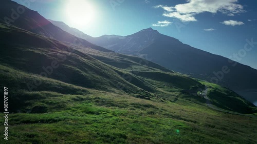 On the shores of Lake Mont Cenis between France and Italy, 4K drone video during a sunrise, green valley with a mystical effect.