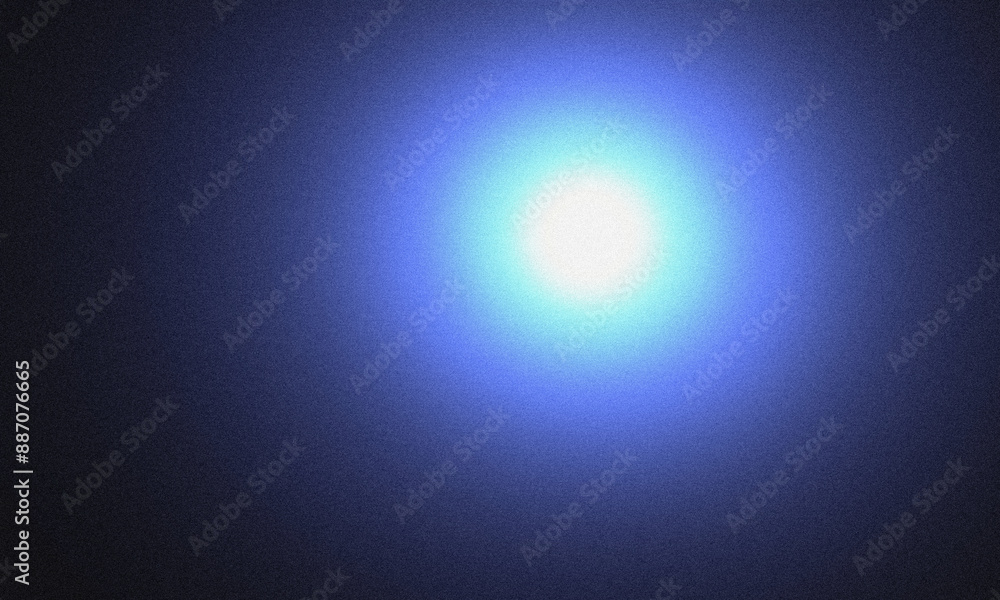 Bright light shining on a grainy blue background Bright light shining on a grainy blue background