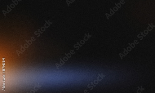 Blue and black abstract grainy texture with a gradient fading into orange