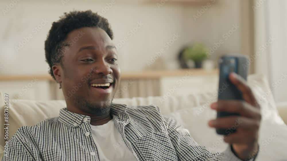 Portrait of happy male internet user, black man using app in modern smartphone. Joyful smiling African American guy surfing internet and viewing social media, addicted male person with mobile gadget Portrait of happy male internet user, black man using app in modern smartphone. Joyful smiling African American guy surfing internet and viewing social media, addicted male person with mobile gadget