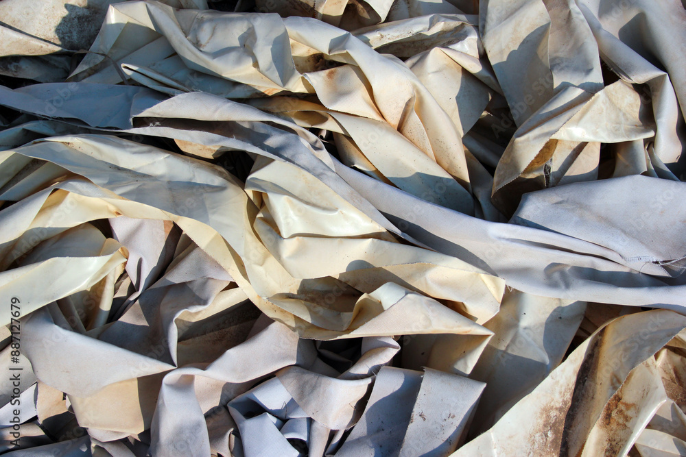 Old scraps of white tarpaulin as background Old scraps of white tarpaulin as background