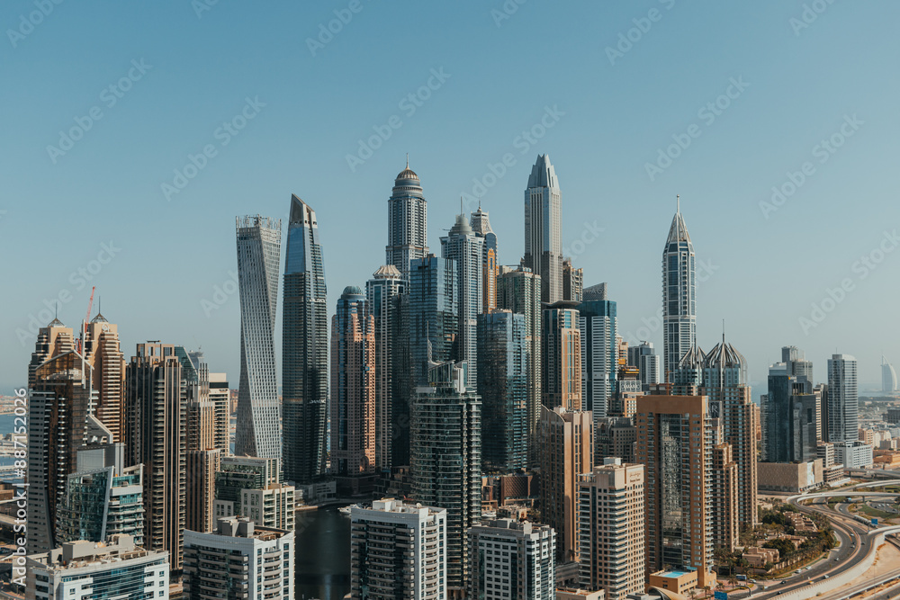 Fototapeta premium Stunning panoramic view of city skyline with skyscrapers and blue sky