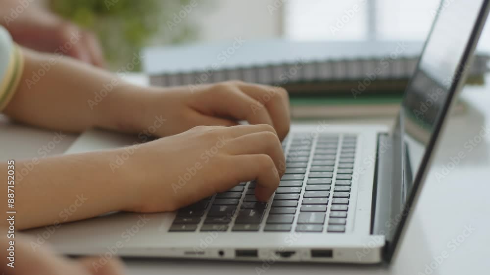Close up of hands if unrecognizable tutor helping kid with laptop keyboard during computer class Close up of hands if unrecognizable tutor helping kid with laptop keyboard during computer class