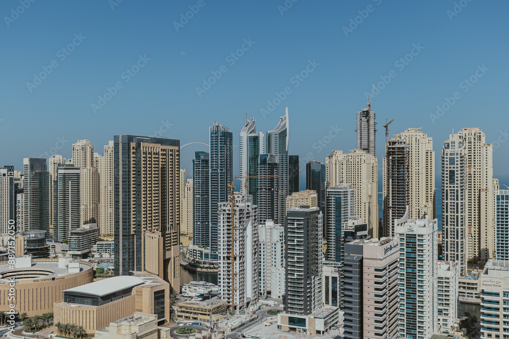 Fototapeta premium Stunning panoramic view of city skyline with skyscrapers and blue sky
