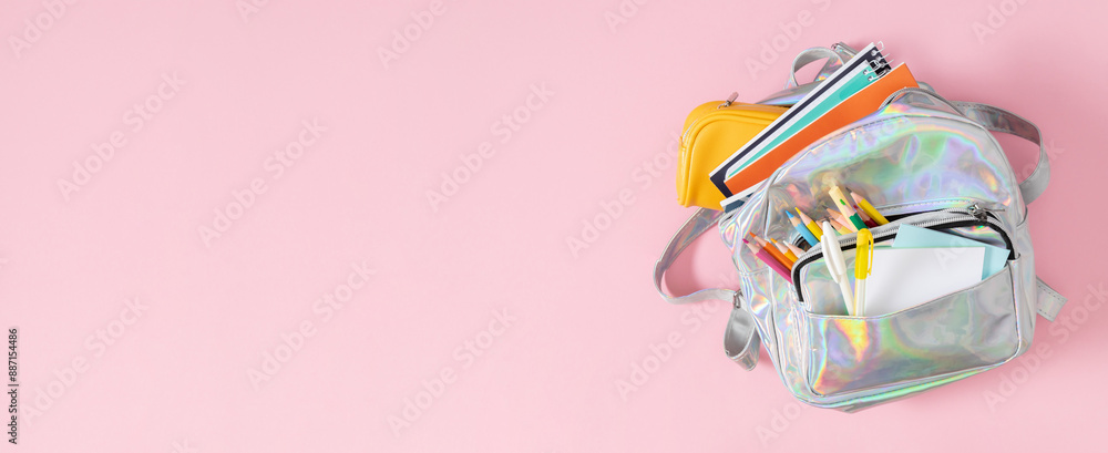 Backpack with school supplies for study isolated on pink background. Back to school concept. Full school backpack. Flat lay, top view Backpack with school supplies for study isolated on pink background. Back to school concept. Full school backpack. Flat lay, top view