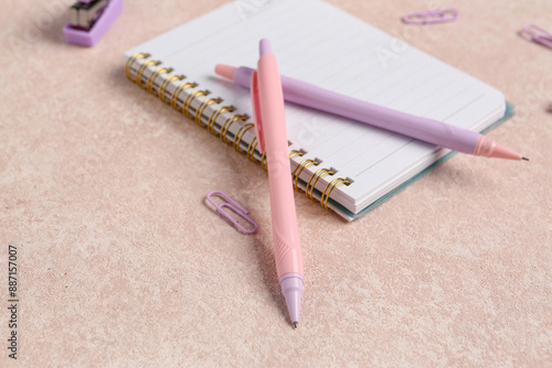 Pink and purple pens on spi...