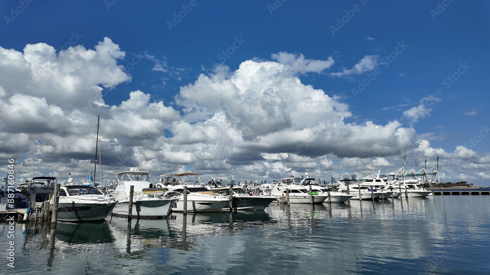 Fototapeta premium Yacht in navigation. Private luxury boat anchored off Miami beach. Summer boat vacation. Miami yachting. Yacht vacation in summer. Marina bay. A luxury motor yacht in sea marina bay. Luxury travel