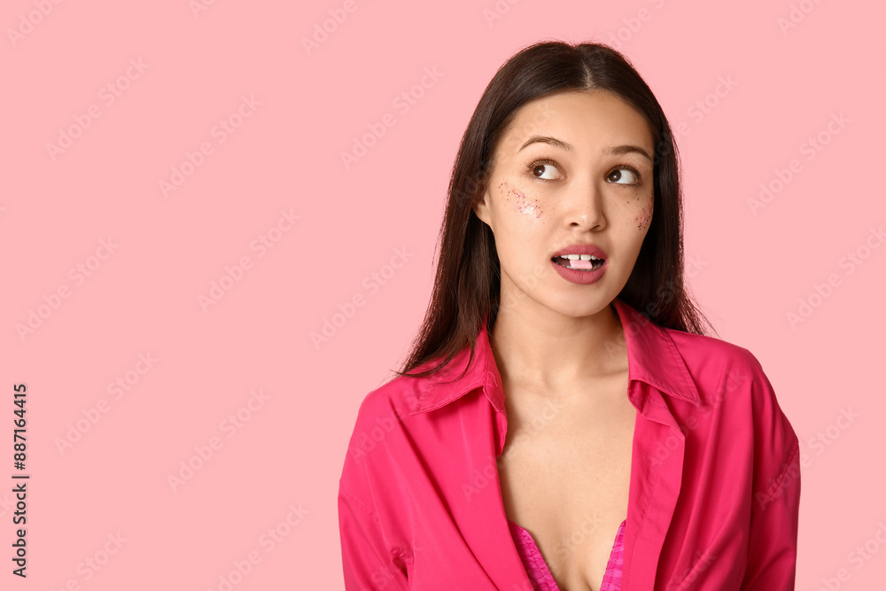Beautiful young Asian woman with chewing gum on pink background Beautiful young Asian woman with chewing gum on pink background