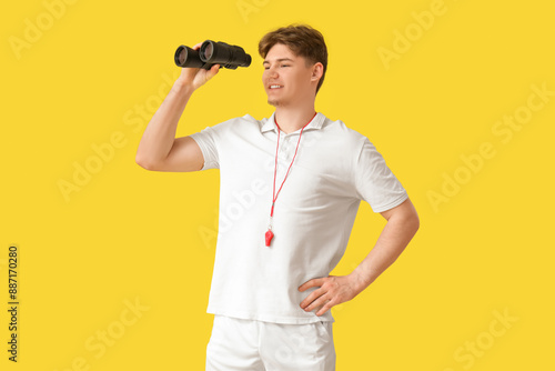 Male lifeguard with binocul...