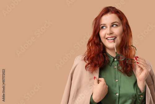 Smiling young redhead woman...