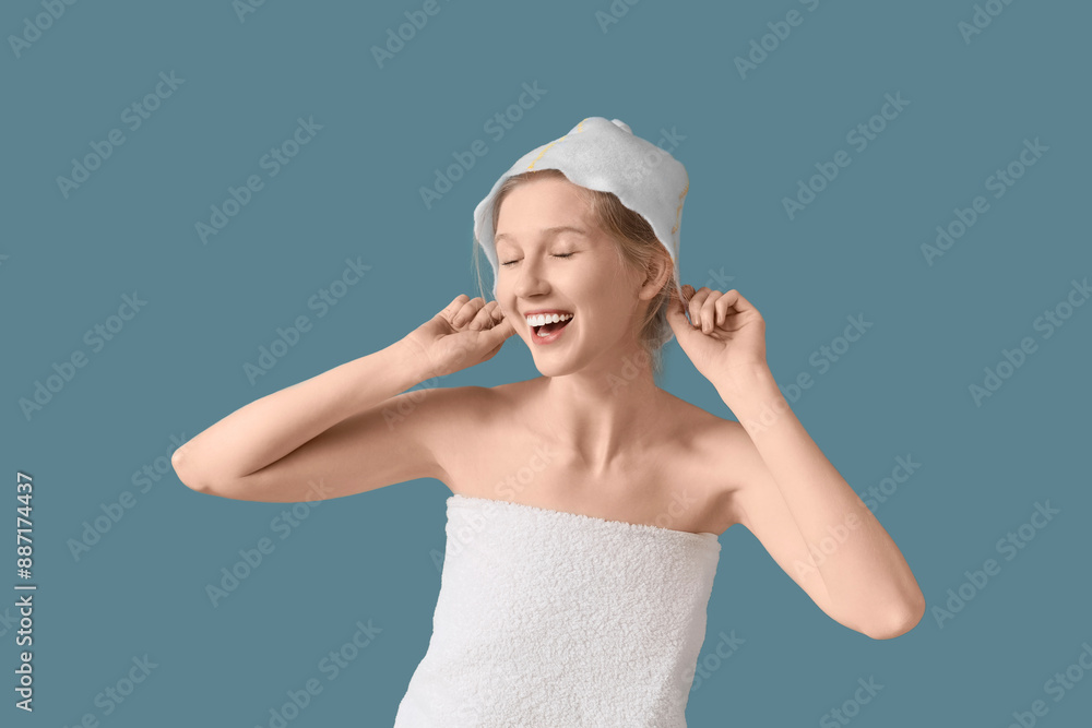 Young woman in sauna hat on blue background Young woman in sauna hat on blue background