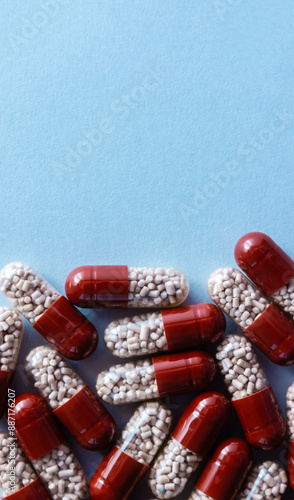Capsules with enzyme preparation to improve digestion. Medical concept of taking medication. Vertical banner, copy space