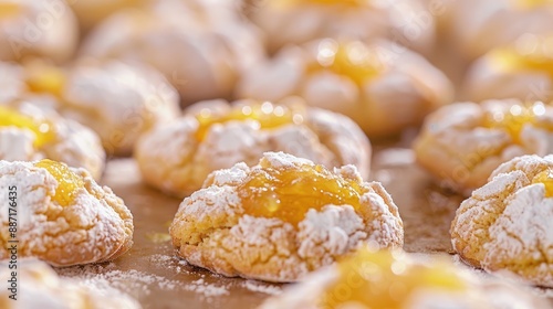 Close up of many homemade freshly baked semolina crinkle cookies with apricot or peach jam and powdered sugar icing Selective focus and shallow depth of field photo