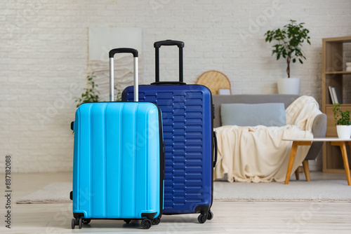 Packed suitcases in interior of living room photo