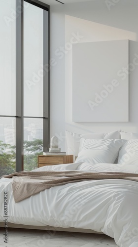 Minimalist bedroom interior with white bedding and a blank canvas.