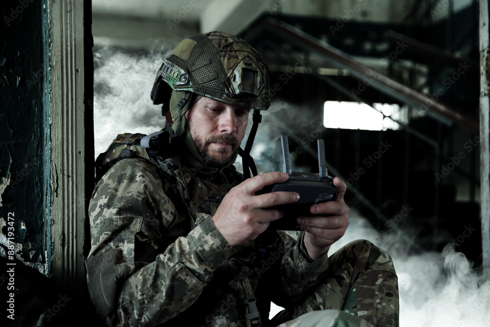 Soldier with drone controller inside building during military operation Soldier with drone controller inside building during military operation