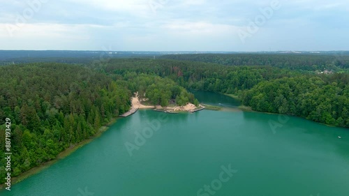 Aerial view of beautiful Balsys lake, one of six Green Lakes, located in Verkiai Regional Park. Birds eye view of scenic emerald lake surrounded by pine forests. Vilnius city, Lithuania. photo